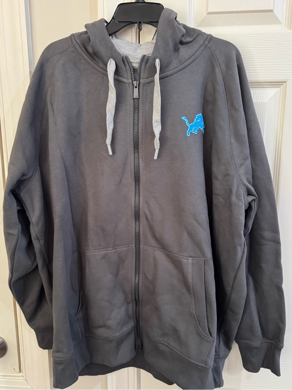 Antigua Charcoal Zip Hoodie with Bright Blue Detroit Lions Patch